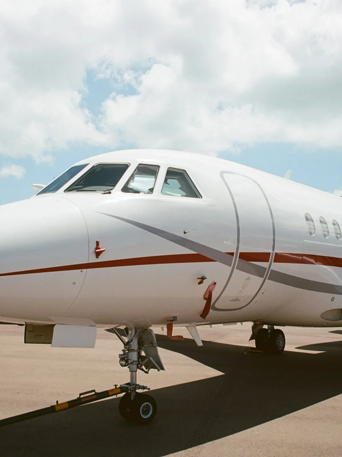 Nose and cockpit of a large cabin Falcon jet on the ramp